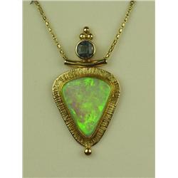 Stylish 14 karat yellow gold ladies custom  made pendant bezel set with a very fine play  of color A