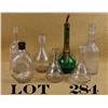 Image 2 : Collectible lot of seven back bar bottles  including a scalloped bottle marked in white  enamel “Bla