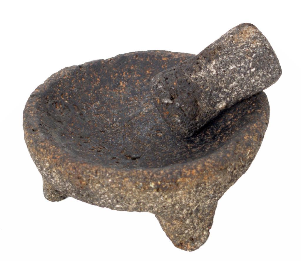 Volcanic rock ceremonial grinding bowl with pestle appearing to be of
