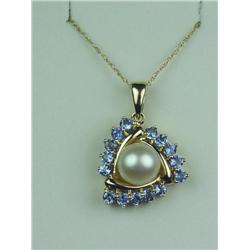 Charming 14 karat yellow gold ladies custom  made pendant set with a center round pearl  averaging 7