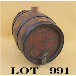 Antique oak keg with iron bands approx. 10”  in length and approx. 7” in diameter with an  old cast 