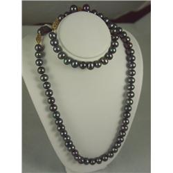 Very elegant ladies round black pearl  ensemble set consisting of necklace and  bracelet averaging 8