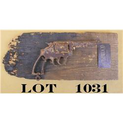 Rusty relic DA revolver mounted on partially  burned piece of barn wood with old plaque  attached “R