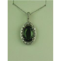 Majestic 10 karat white gold ladies pendant  set with a center oval green Tsavorite garnet  weighing