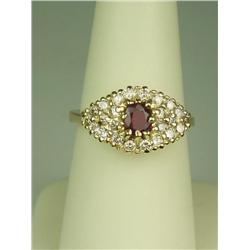Vibrant 14 karat yellow gold ladies ring set  with a center red ruby weighing approx. 0.60  carats a