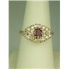 Image 1 : Vibrant 14 karat yellow gold ladies ring set  with a center red ruby weighing approx. 0.60  carats a
