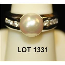 Ladies 14kt white gold ring weighing 6.5  grams set with an 8mm pearl and six diamonds  weighing .25