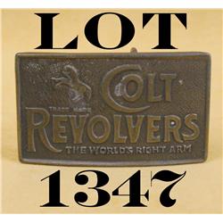 Brass belt buckle approx. 2-1/4” x 4” with  raised “Colt Revolvers, The World’s Right  Arm” and a Ra