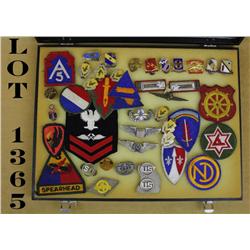 Lot of approx. 40, mostly U.S., military  patches and pins contained in a large riker  case includin