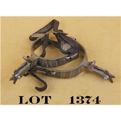 Pair of metal spurs with engraved silver  panels on one side of each spur, only marking  is an “ST” 