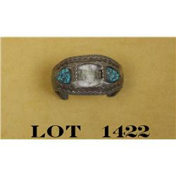 Silver and turquoise watchband showing two  turquoise nuggets on either side of the watch  face area