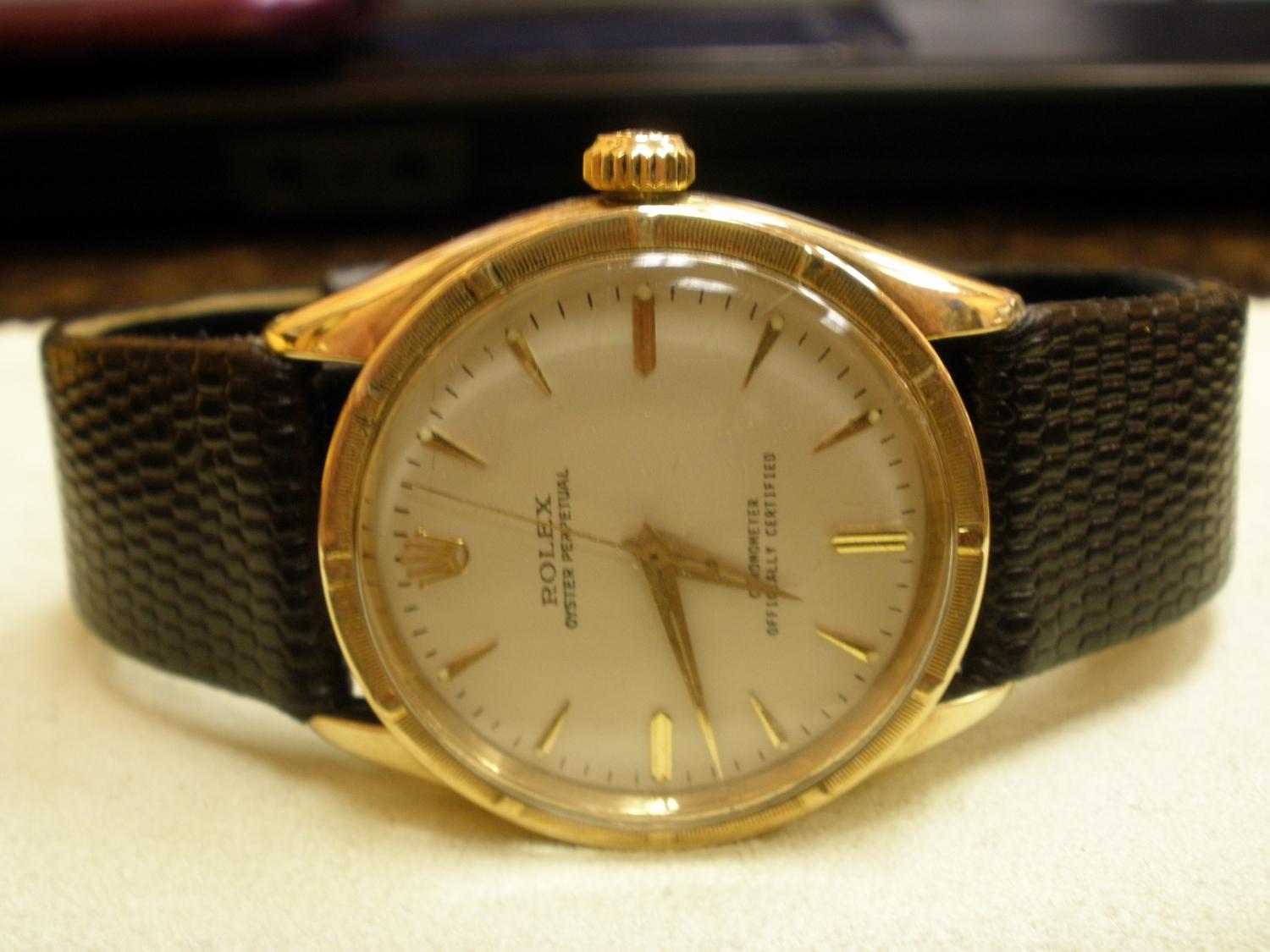 ROLEX OYSTER PERPETUAL 18K YELLOW GOLD CHRONOMETER ON BLACK LEATHER STRAP