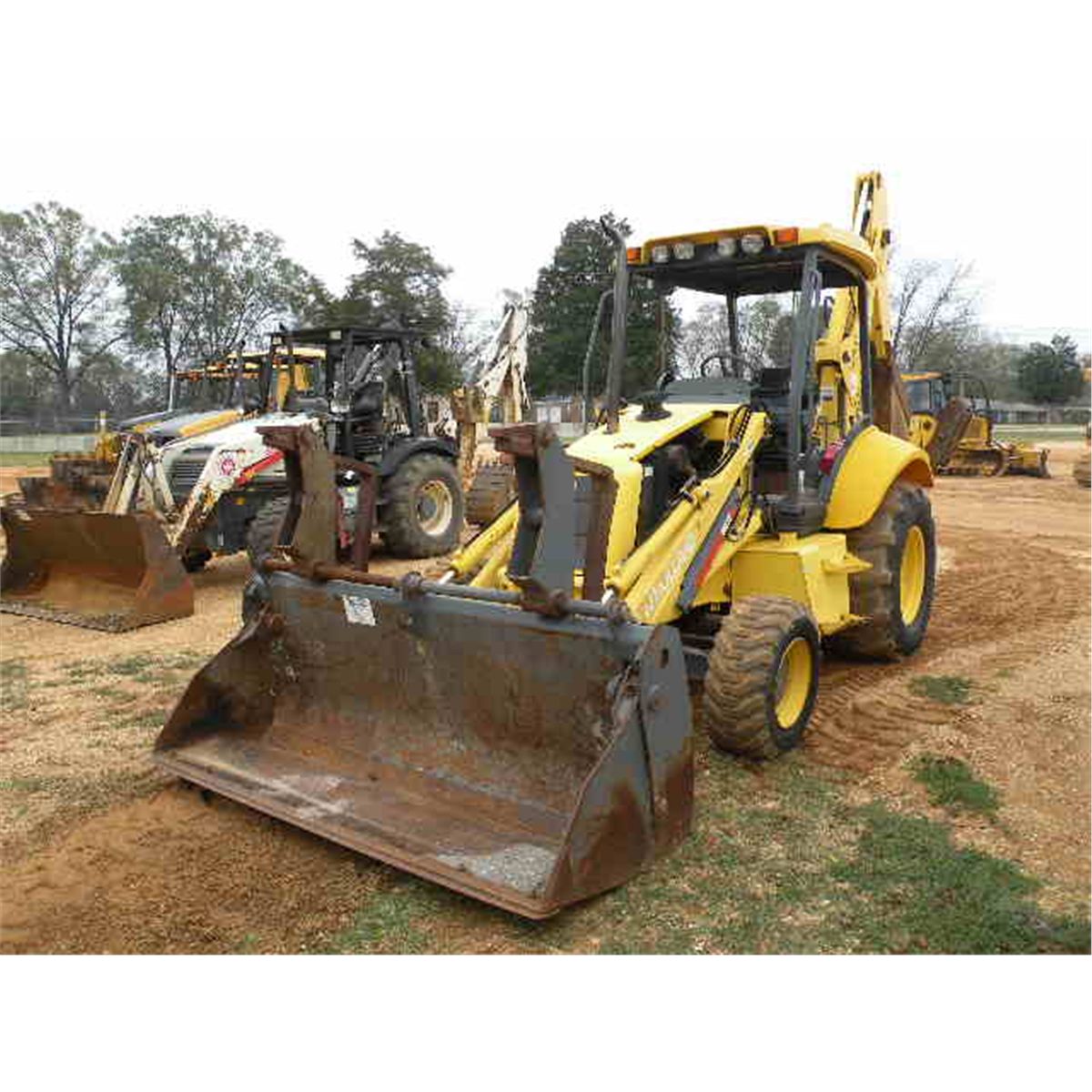 NEW HOLLAND LB75B LOADER BACKHOE J.M. Wood Auction Company, Inc.