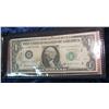 Image 2 : 980. Joseph Barr $1 Note in folder with Certificate and vinyl holder.