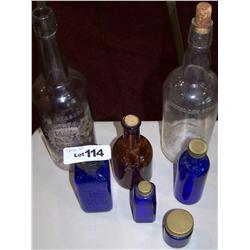 7 pc. Vintage Glass Bottle Lot.. 4 Cobalt. 1 Brown and 2 Large Clear Bottles.