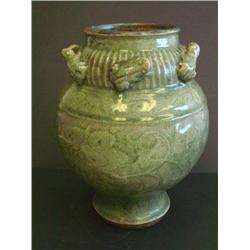 Green vase with design of frogs around collar