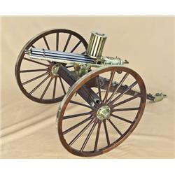 Miniature exposed-barrel Gatling gun with  canister feed on field carriage. .22 long  rifle caliber,