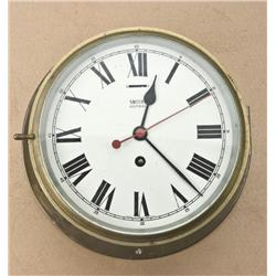 Large brass key wind ship’s clock with  beveled glass face cover by Smith of Great  Britian, approx.
