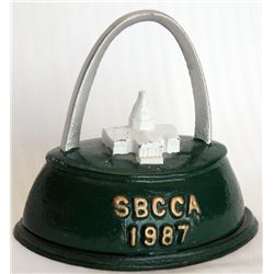 SBCCA (Still Bank Collectors Club of America. St. Louis, Mo. 1987. Shape of an iron. Coin opening on