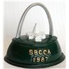 Image 1 : SBCCA (Still Bank Collectors Club of America. St. Louis, Mo. 1987. Shape of an iron. Coin opening on