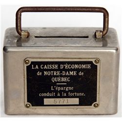 LA CAISSE D’ECONOMIE DE NOTRE-DAME DE QUEBEC. A small rectangular steel satchel bank with rounded ed