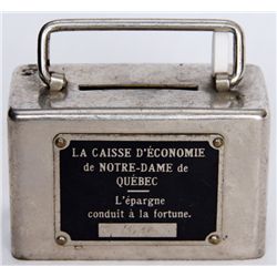 LA CAISSE D’ECONOMIE DE NOTRE-DAME DE QUEBEC. A small rectangular steel satchel bank. Coin slot on t