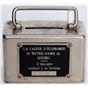 Image 1 : LA CAISSE D’ECONOMIE DE NOTRE-DAME DE QUEBEC. A small rectangular steel satchel bank. Coin slot on t