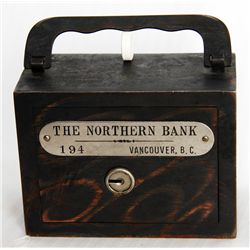 THE NORTHERN BANK, VANCOUVER, B.C. A steel satchel bank, with square corners. Coin slot at right, wi