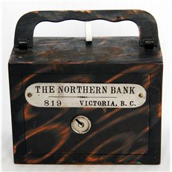 THE NORTHERN BANK, VANCOUVER, B.C. A steel satchel bank, with square corners. Coin slot at right, wi