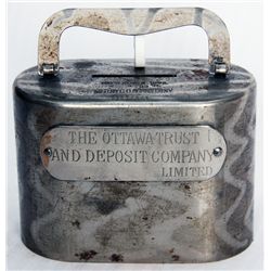 THE OTTAWA TRUST AND DEPOSIT COMPANY LIMITED. An oval satchel bank. Coin slot on top. Handle at top.