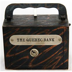 THE QUEBEC BANK. A rectangular steel satchel bank, with square corners. Coin slot on right side, wit