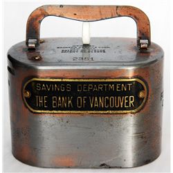 SAVINGS DEPARTMENT THE BANK OF VANCOUVER, VANCOUVER, B.C. An oval steel satchel bank. Coin slot on l