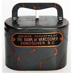 SAVINGS DEPARTMENT THE BANK OF VANCOUVER, VANCOUVER, B.C. An oval steel satchel bank. Coin slot on l