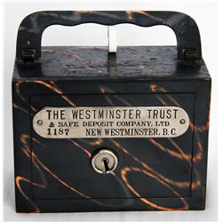 THE WESTMINSTER TRUST & SAFE DEPOSIT COMPANY, LTD. NEW WESTMINSTER, BC. A steel satchel bank, with s