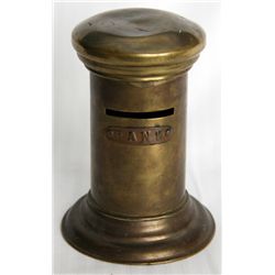 BANK’. A bank in the shape of a Cylinder, with flans at top and base. Coin slot at top. No handle, k