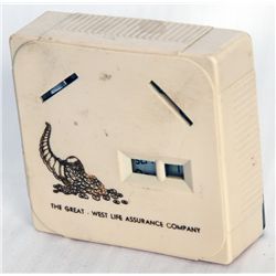 THE GREAT-WEST LIFE ASSURANCE COMPANY. A rectangular Coin Calendar bank. Two coin slots in front. Cu