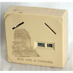 SUN LIFE OF CANADA. A rectangular Coin Calendar bank. Two coin slots on front. Currency slot on back