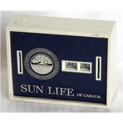 SUN LIFE OF CANADA. A rectangular Coin Calendar bank. Two coin slots on front. Currency slot on back