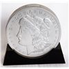 Image 1 : U.S. MORGAN SILVER DOLLAR. (E. PLURIBUS UNUM). A coins shape on base, silver coloured plastic bank. 