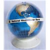 Image 1 : NATIONAL WESTMINSTER BANK (B.C.). A Globe Shaped, blue, gold & white plastic bank. Coin slot on top.