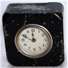 Image 1 : A rectangular shaped Clock Bank. Two coin slots on top. 9 1/2cm x 4cm x 9 1/2cm. Steel, with a black