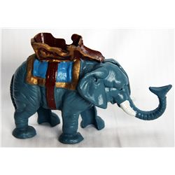 A Mechanical bank shaped like an Elephant. Trunk shots coin into slot on back. 16cm x 13cm x 6cm. Ca