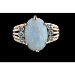Beautiful Ladies Oval Shaped Opal Ring Three round cut diamonds on each side of opal, set in 14K yel