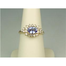 Dazzling 14K Yellow Gold Ladies Ring Set with a center oval Tanzanite weighing approx. 1.00 carat an