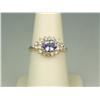 Image 1 : Dazzling 14K Yellow Gold Ladies Ring Set with a center oval Tanzanite weighing approx. 1.00 carat an