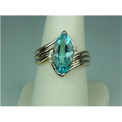 Ladies 14K YG Bypass Ribbed Design Ring Set with a fine center MQ cut sky blue topaz weighing approx