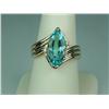 Image 1 : Ladies 14K YG Bypass Ribbed Design Ring Set with a fine center MQ cut sky blue topaz weighing approx