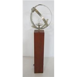 Metal sphere lamp on wooden stand