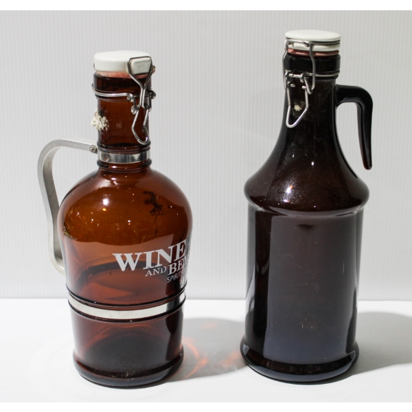 TWO BROWN GLASS WINE / BEER HANDLED JUGS