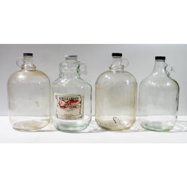 FOUR VINTAGE GLASS WINE JUGS